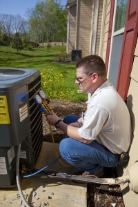 HVAC contractor working on ac unit