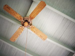 ceiling fan on grey beamed ceiling