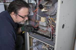 technician-servicing-gas-furnace