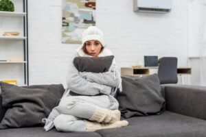 woman-hugging-pillow-looking-cold