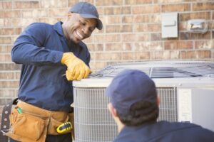 two-technicians-working-on-outdoor-ac-unit