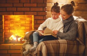 woman-and-child-by-fireplace-reading