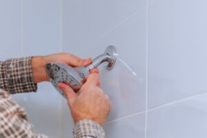 hands-working-on-shower-head