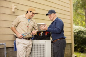 two-technicians-working-on-air-conditioner