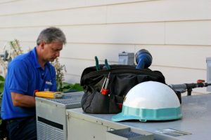 technician-repairing-an-AC-unit